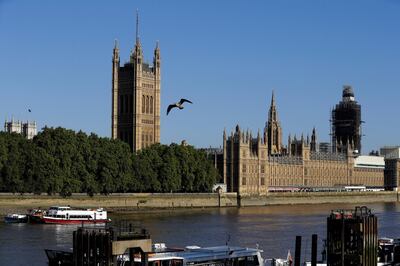 A seagull flies past Britain's Houses of Parliament on the bank of The River Thames in London, Thursday, Aug. 29, 2019. Jacob Rees-Mogg, The leader of the British House of Commons has defended Prime Minister Boris Johnson's move to suspend parliament, a move that gives his political opponents less time to block a no-deal Brexit before the October 31 withdrawal deadline. (AP Photo/Kirsty Wigglesworth)