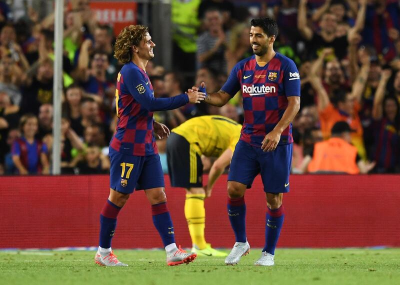 Antoine Griezmann and Luis Suarez of Barcelona celebrate as Ainsley Maitland-Niles of Arsenal scores an own goal. Getty