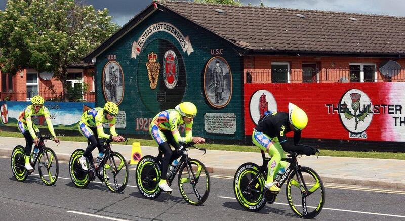 Riders of Neri Sottoli team cycle past pro-British Loyalist murals in Belfast during the first stage of the 2014 Giro d'Italia on Friday. Paul McErlane / EPA