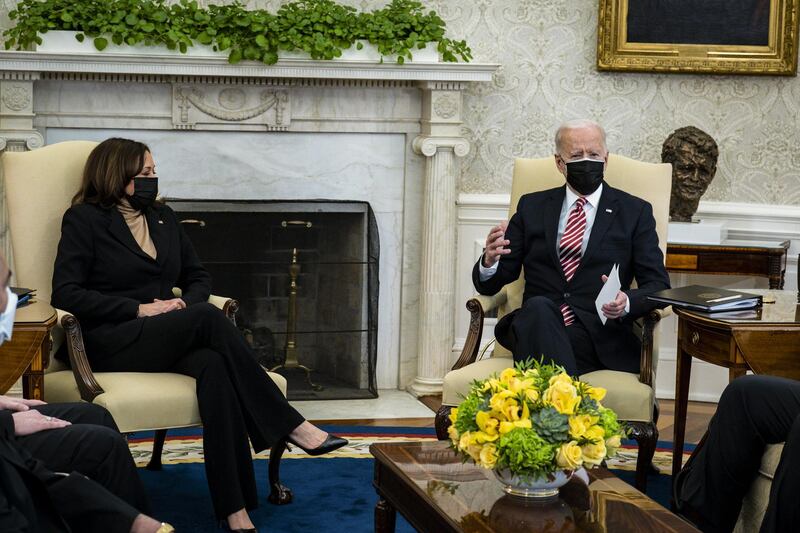 U.S. President Joe Biden wears a protective mask while speaking as U.S. Vice President Kamala Harris, left, listens during a meeting with labor leaders on coronavirus relief in the Oval Office of the White House in Washington, D.C., U.S. Biden said last night in a CNN town hall event that Moderna Inc. and Pfizer Inc. agreed to sell more doses of their coronavirus vaccine to the U.S. faster than planned after he invoked federal law that could force their production. Bloomberg