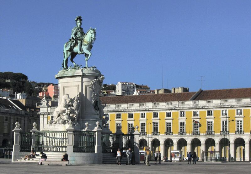 LISBON, PORTUGAL - JULY 23:  Tourists walk by a statue of Jose I at Praca de Comercio on July 23, 2008 in Lisbon, Portugal. Portugal is becoming an increasingly popular tourist destination.  (Photo by Sean Gallup/Getty Images)