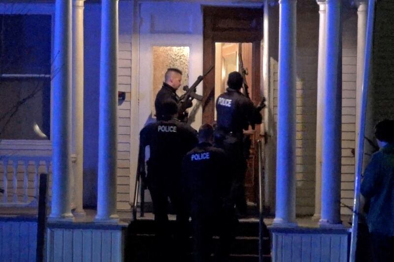 Police search a house after a gunman shot and wounded three 20-year-old college students of Palestinian descent in Burlington, Vermont, eastern US. Reuters