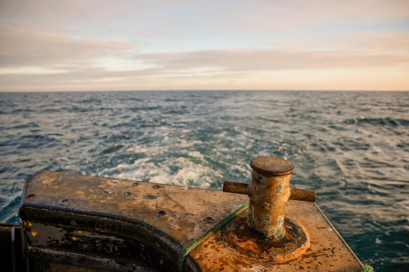 Looking out to sea beyond a mooring post at the stern of fishing boat 'About Time' while trawling in the English Channel from the Port of Newhaven, East Sussex, U.K. on Sunday, Jan. 10, 2021. While Prime Minister Boris Johnson claimed last month’s trade deal will let the U.K. regain control of its fishing waters by taking back 25% of the European Union’s rights over five years, many fishermen feel let down. Photographer: Jason Alden/Bloomberg