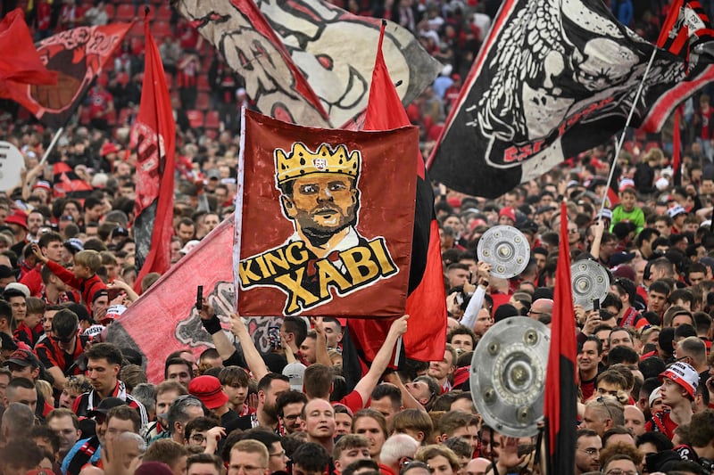 Leverkusen fans with a banner of "King Xabi" - a tribute to head coach Xabi Alonso. AFP