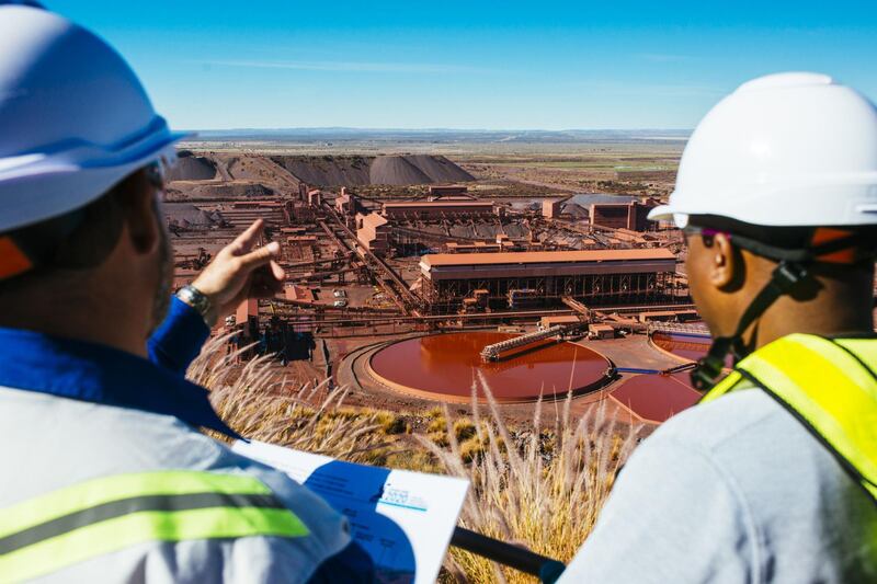 Visitors look out towards the iron ore processing plant at the Sishen open cast mine, operated by Kumba Iron Ore Ltd., an iron ore-producing unit of Anglo American Plc, in Sishen, South Africa, on Tuesday, May 22, 2018. Kumba Iron Ore may diversify into other minerals such as manganese and coal as Africa’s top miner of the raw material seeks opportunities for growth and to shield its business from price swings. Photographer: Waldo Swiegers/Bloomberg