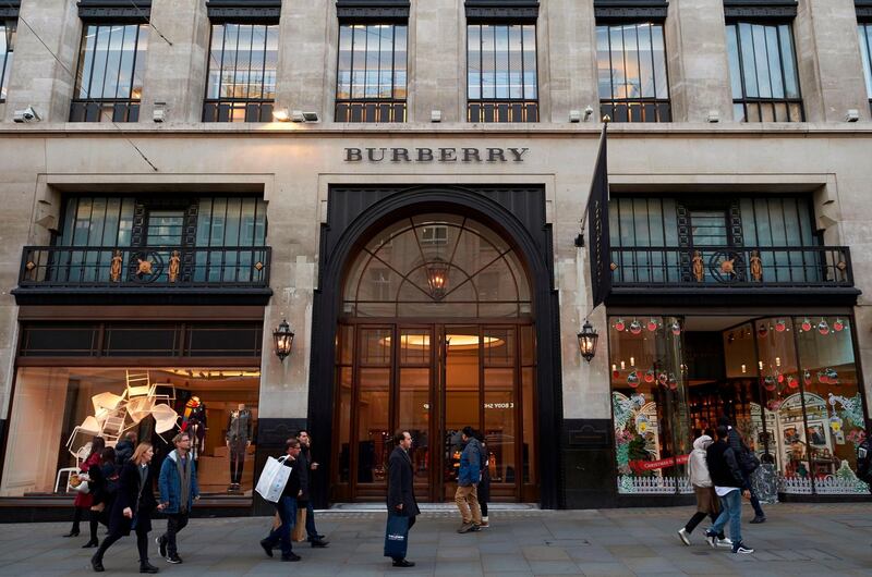 (FILES) In this file photo taken on November 09, 2017 pedestrians pass the Burberry store as they walk along Regent Street in central London. - British luxury fashion group Burberry has stopped burning unsold products and will no longer use real fur and angora in its clothes, chief executive Marco Gobbetti revealed on September 6, 2018. (Photo by Niklas HALLEN / AFP)
