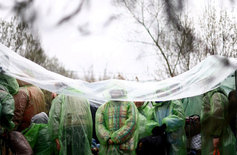 Ukrainian refugees wait in line to cross the border into Poland at Shehyni. Reuters