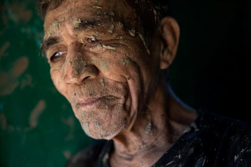 A man takes a break from cleaning his house, which was covered in mud after flooding caused by Typhoon Vamco, in San Mateo, Rizal province, Philippines. Reuters