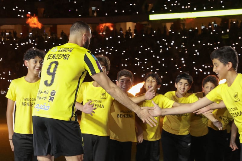 Karim Benzema greets young Al Ittihad fans during his unveiling at King Abdullah Sports City stadium in Jeddah. AFP