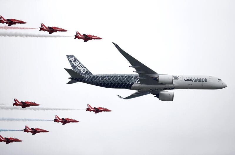 FILE PHOTO: An Airbus A350 aircraft flies in formation with Britain's Red Arrows flying display team at the Farnborough International Airshow in Farnborough, Britain July 15, 2016.  REUTERS/Peter Nicholls/File Photo