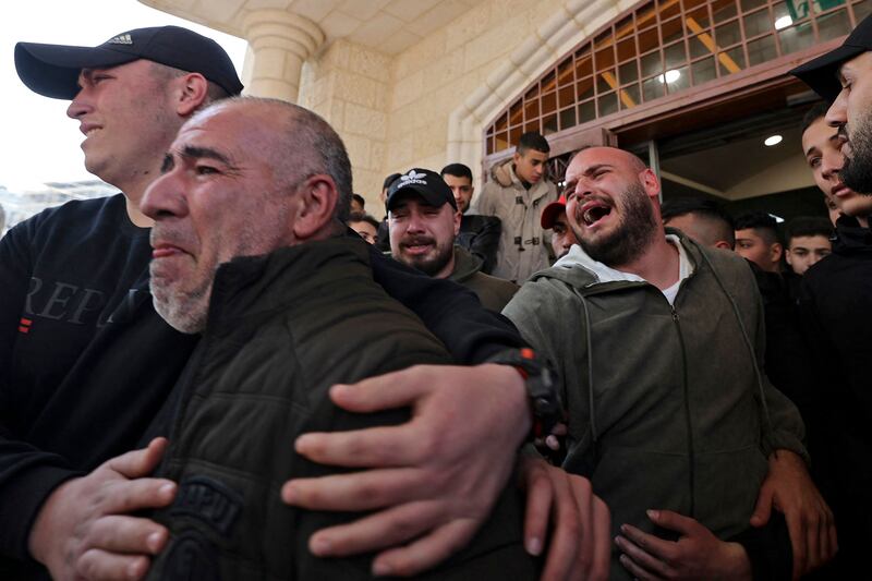 Relatives outside a hospital mourn the death of a Palestinian killed in the Israeli raid. AFP
