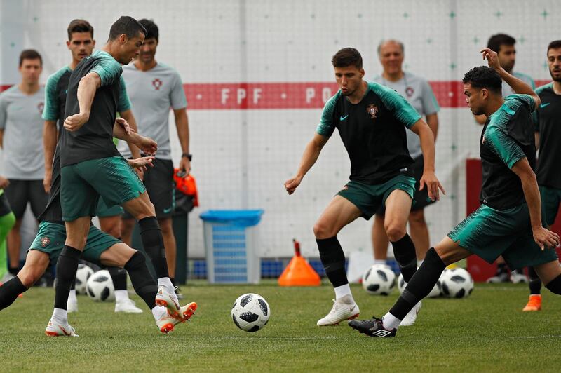 Portugal's Cristiano Ronaldo, left, plays the ball with teammates during Portugal's official training on the eve of the group B match between Portugal and Morocco at the 2018 soccer World Cup, in Kratovo, outskirts Moscow, Russia, on June 19, 2018. Francisco Seco / AP Photo