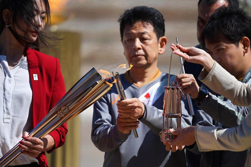 Former Japanese swimmer Naoko Imoto lights the Olympic flame. EPA