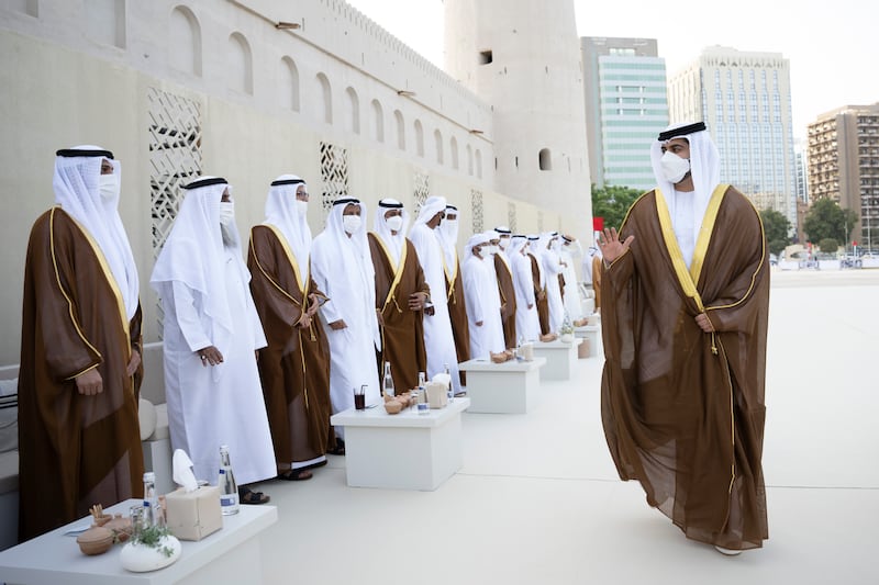 Sheikh Zayed bin Mansour bin Zayed greets grooms during his group wedding with Sheikh Hazza bin Hamdan bin Zayed (not shown) at Qasr Al Hosn. 