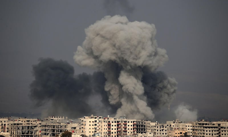 Smoke plumes rise following a reported regime air strike in the rebel-held town of Hamouria, in the besieged Eastern Ghouta region. Abbdulmonam Eassa / AFP