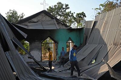 Villagers inspect the debris of a ransacked church that was set on fire in the Senapati district of Manipur. AFP