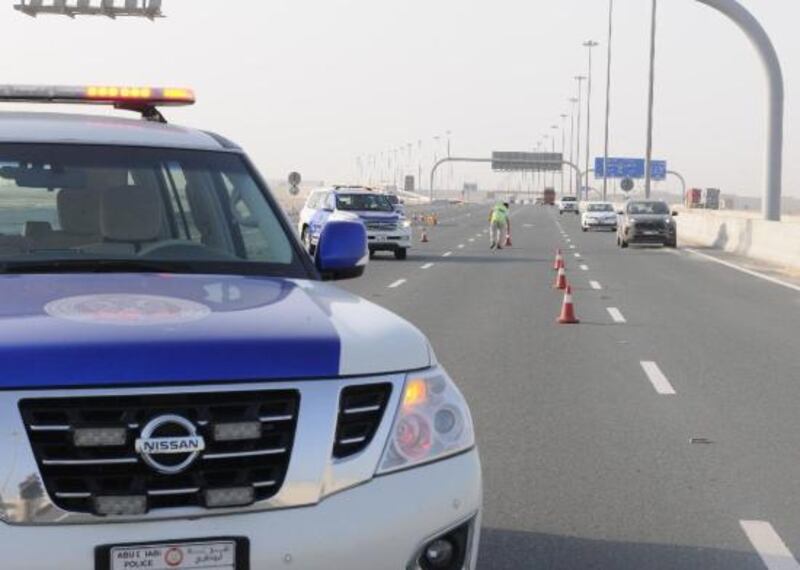 Abu Dhabi Police, pictured attending to an unrelated incident, said a man was arrested after killing three members of his family