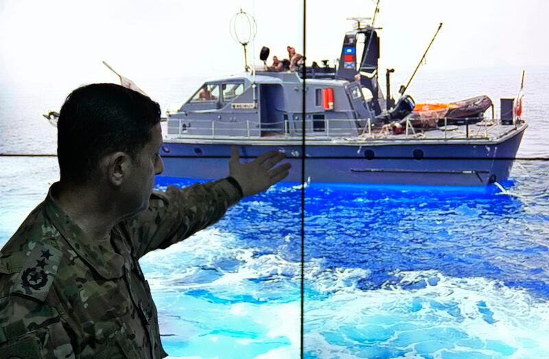 Col Haitham Dinnawi, commander of the Lebanese navy, shows the Lebanese navy boat which was attempting to force a small vessel with migrants to turn back to the shore before it sank, during a press conference in Beirut. AP