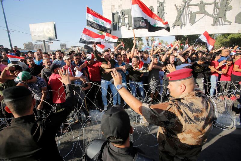 Protesters dispersed by riot police during the protests in Baghdad. Reuters