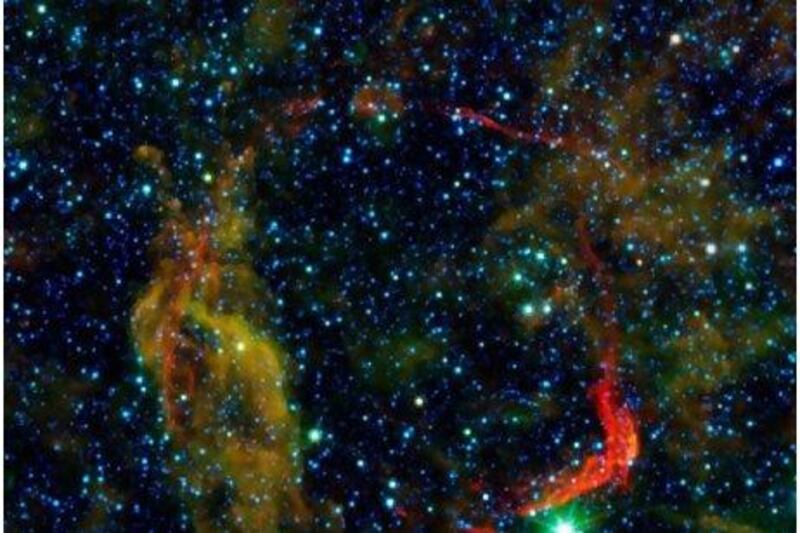 Infrared images from Nasa's Spitzer Space Telescope and the Wide-field Infrared Survey Explorer were combined in this image of RCW 86, the dusty remains of the oldest documented example of a supernova. AFP Photo / Nasa