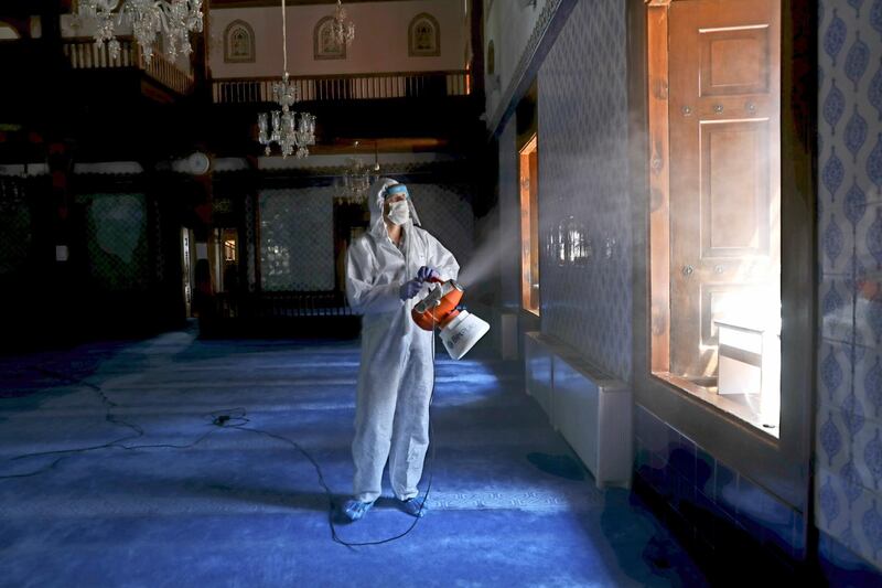 A Municipality worker disinfect the inside of historical Haci Bayram Mosque, in Ankara, Turkey. AP Photo