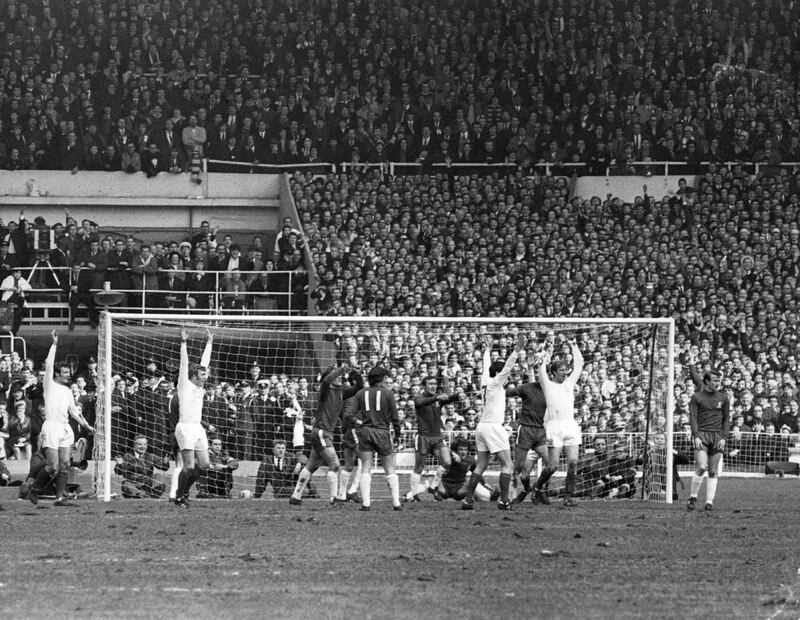 11th April 1970:  Jackie Charlton of Leeds United (right) raises his arms in celebration after scoring his team's first goal from a corner during the FA Cup Final against Chelsea at Wembley Stadium. The match ended in a 2-2 draw after extra time, and Chelsea won the replay 2-1.  (Photo by Douglas Miller/Keystone/Getty Images)
