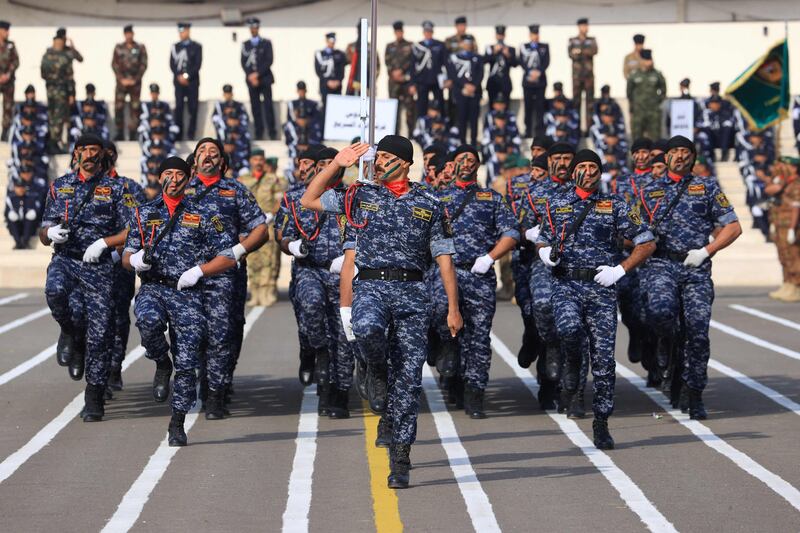 Iraqi officers parade during a ceremony marking Police Day in Baghdad. AFP