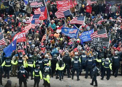 Trump supporters clash with police and security forces as they storm the US Capitol in Washington DC on January 6, 2021. AFP