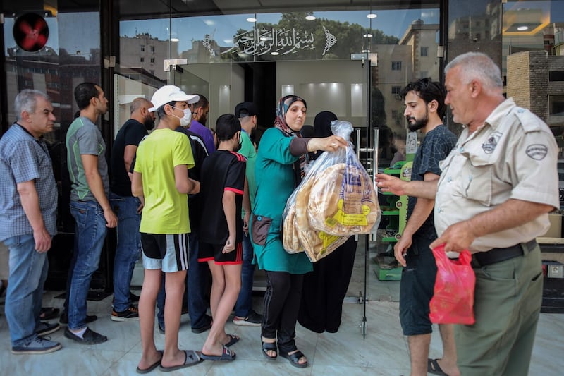 People queue to buy bread at a local bakery in Beirut, Lebanon on June 27. Lebanese officials announced more measures to stabilise the nation’s plunging local currency and rein in soaring food prices that have triggered nationwide protests. Hasan Shaaban/Bloomberg