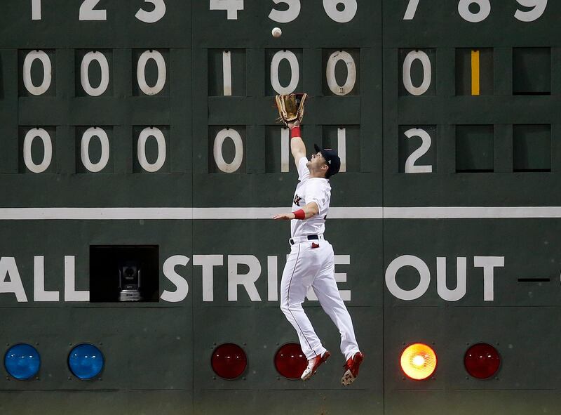 Boston Red Sox's Andrew Benintendi makes the catch on a fly-out by Los Angeles Angels' David Fletcher during the eighth inning of a baseball game in Boston. AP Photo / Michael Dwyer