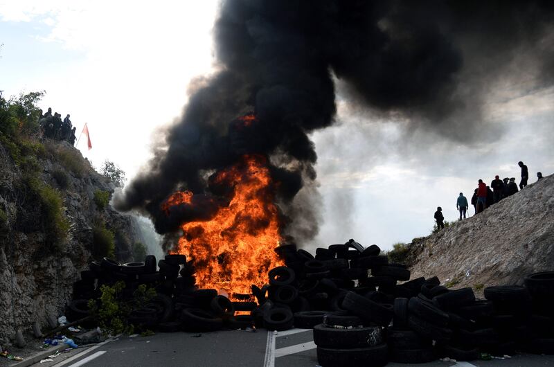 Demonstrators burn tyres during the protests. AFP