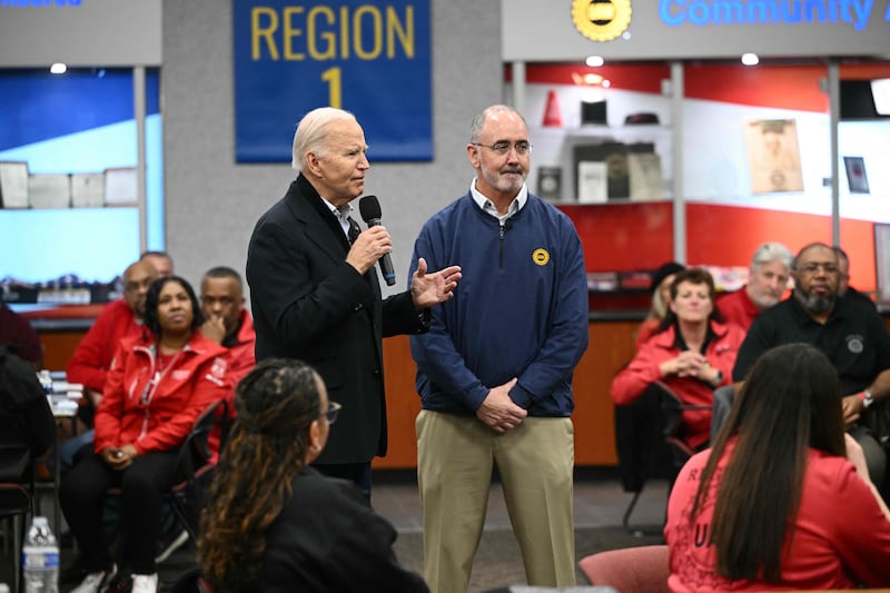 US President Joe Biden speaks alongside UAW president Shawn Fain during a visit to United Auto Workers in Detroit, Michigan. AFP
