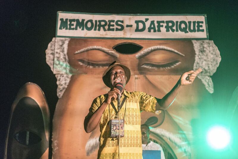 A Togolese professional storyteller speaks to the public gathered in Sainte Cecile Square in Cotonou on August 14, 2018 during the African Memories Festival. (Photo by YANICK FOLLY / AFP)