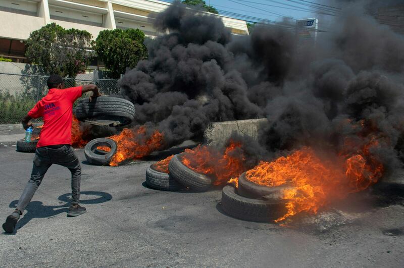 A protester burns tyres during a demonstration following the resignation of Haiti's Prime Minister Ariel Henry in the capital, Port-au-Prince. AFP