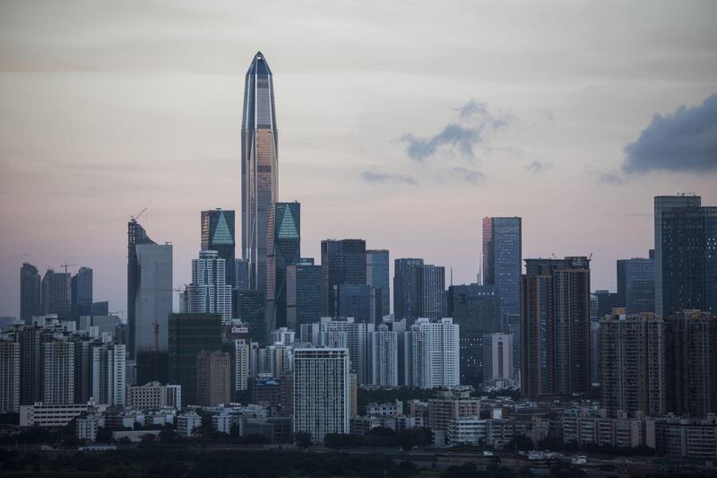 The Ping An International Finance Center (Ping An IFC), centre left, and other buildings at dawn in Shenzhen are seen from the Ma Tso Lung district of Hong Kong, China, on Thursday, June 8, 2017. Shenzhen is pivoting from its legacy as ground zero for China's manufacturing boom into a center for research, development and production of advanced technology. Photographer: Justin Chin/Bloomberg