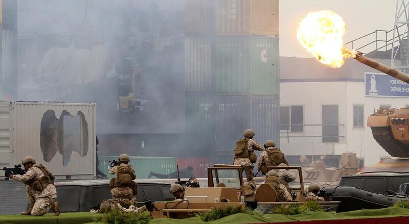 Smoke fills the air at Adnec as the UAE armed forces put on a mock battle. AFP

