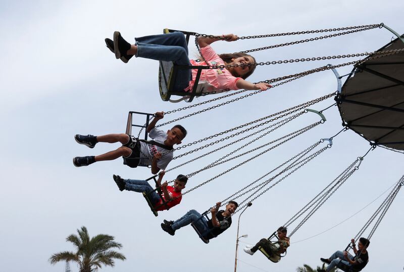 Children enjoy a swing ride during the Muslim holiday of Eid Al Fitr, which marks the end of Ramadan at the port city of Sidon, Lebanon. Reuters