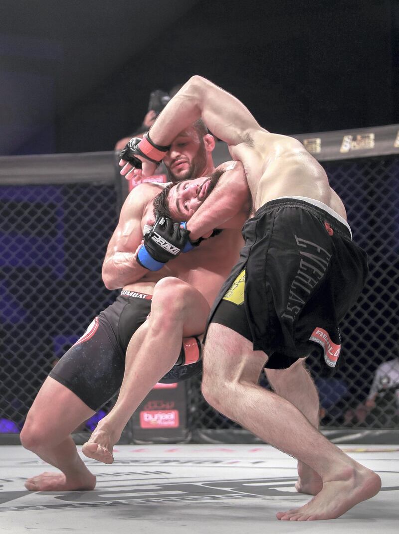 Abu Dhabi, United Arab Emirates, October 4, 2019.   --  Brave Combat Federation 27 at the Mubadala Arena.
Welterweight:
(R-L) Abdoul Abdouraguimov (FRA) gets choked by Jarrah Al Selawe (JOR) during the main event.
Victor Besa / The National
Section:  SP
Reporter:  Amith Passela