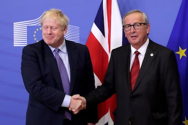 British Prime Minister Boris Johnson and President of the European Comission Jean-Claude Juncker shake hands during a press conference on the Brexit deal. EPA