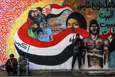 A mural in Baghdad’s Tahrir Square depicts protesters wrapped in the Iraqi flag. AFP