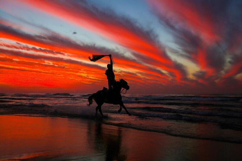 A Palestinian horseman rides on the beach at sunset a few hours prior to the new year's celebrations, west of in Gaza city.  AFP