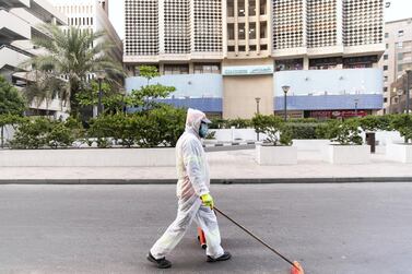 DUBAI, UNITED ARAB EMIRATES. 9 APRIL 2020. A man cleans the streets by Baniyas Square. (Photo: Reem Mohammed/The National) Reporter: Section: