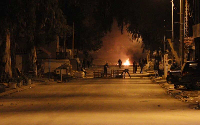 Protesters block a street during clashes with security forces in the Ettadhamen city suburb of Tunis, Tunisia.  EPA