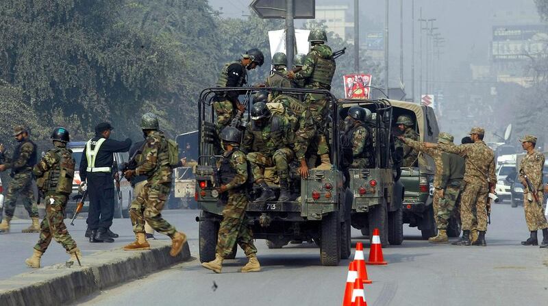 Pakistani army troops arrive to conduct an operation at a school under attack by Taliban gunmen in Peshawar. Taliban gunmen stormed a military school in the northwestern Pakistani city, killing and wounding dozens, officials said, in the latest militant violence to hit the already troubled region. Mohammad Sajjad / AP Photo