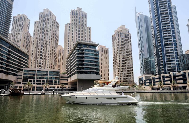 A luxury yacht is pictured at the Dubai Marina Beach in the Gulf emirate, on June 10 2021.
 Dubai earned a reputation for delivering luxury for those with cash to splash years ago, but amid the Covid-19 pandemic, a new mode of travel has become popular, yachts.
Charter companies said they have seen an increased interest in yachting after coronavirus measures eased, especially among those who want to spend time with friends and family. / AFP / Karim SAHIB
