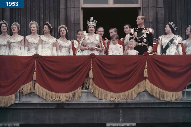 1953: The queen and the Duke of Edinburgh wave at the crowds from the balcony of Buckingham Palace in London, after the queen's coronation, on June 2.