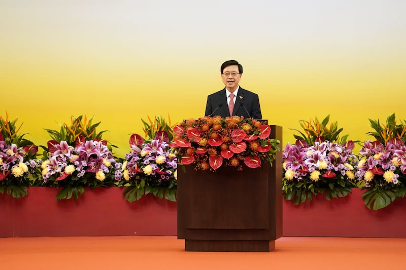 His inauguration followed a morning flag-raising ceremony attended by departing leader Carrie Lam and several hundred other people. Bloomberg