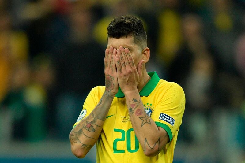 Brazil's Roberto Firmino reacts after missing his penalty by sending the ball wide in the penalty shoot-out. AFP