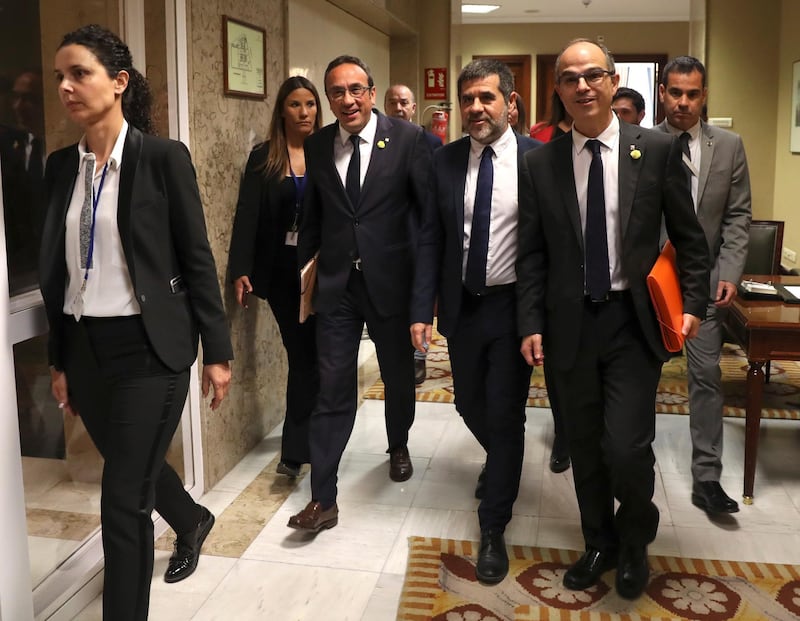 epa07586367 Josep Rull (3-L), Jordi SÃ nchez (3-R), and Jordi Turull (2-R), imprisoned MPs-elect of Catalan party Junts per Catalunya, chat as they leave after processing their parliamentary acts at Lower Chamber of Spanish Parliament, in Madrid, Spain, 20 May 2019. The four imprisoned Catalan MP elect arrived in the Chamber from the jail for processing the necessary documentation ahead of taking over their seats a day after at Spanish Lower Chamber. The four politicians are in preventive detention during their trial for their allegedly involvement in the illegal pro-independence referendum held 01 October 2017.  EPA/J.J. Guillen