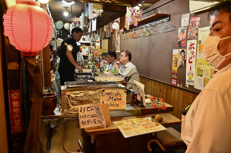 Face masks are likely to remain in most indoor places in Japan. AFP